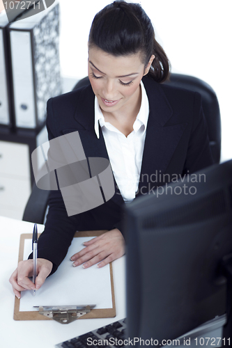 Image of Portrait of young business woman working at her office