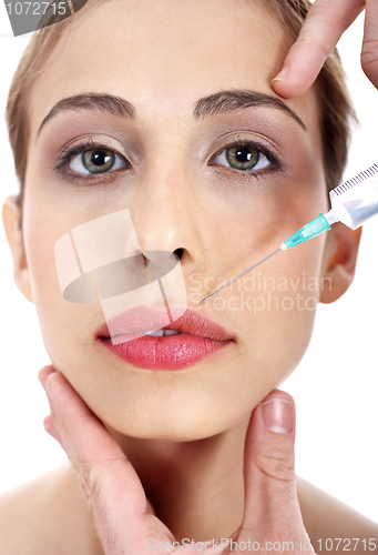 Image of Close up face of a young young face being injected on face