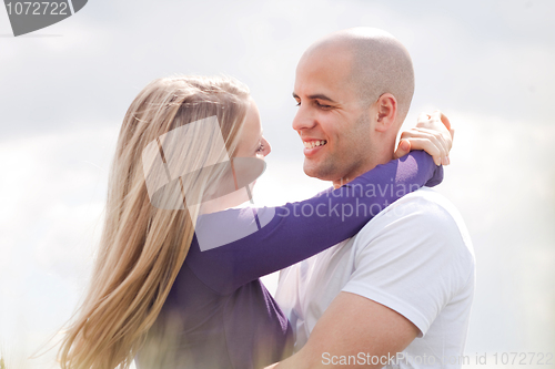 Image of Loving couple standing under the blue sky