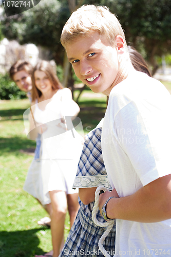 Image of Happy Friends pulling a rope against each other