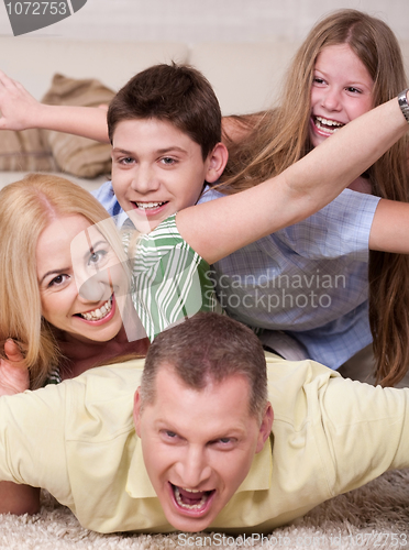 Image of Happy family Lying On Top Of Each Other