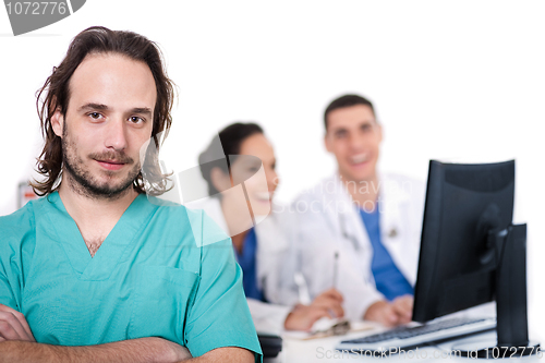 Image of Male doctor on focus, two doctors discussing at background