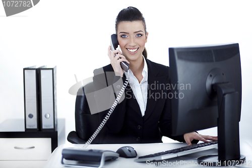 Image of Smiling woman busy over phone