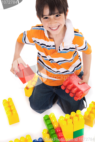 Image of Young boy playing with building blocks