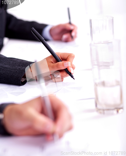 Image of Business people taking notes in the business conference