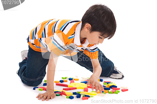 Image of Cute kid inprocess of joining the blocks