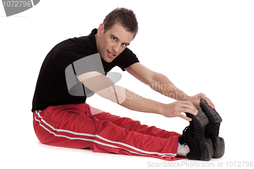 Image of Fitness men stretches his leg