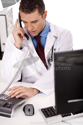Image of adult  physician sitting at his desk