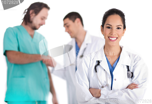 Image of Attractive young doctor smiling, other doctor giving shake hand to male nurse