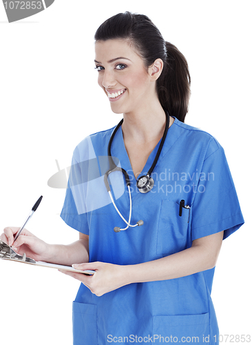 Image of Smiling cute nurse making her medical notes