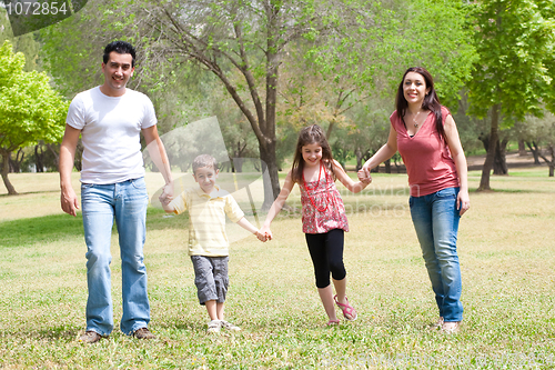 Image of Family posing to camera in the park