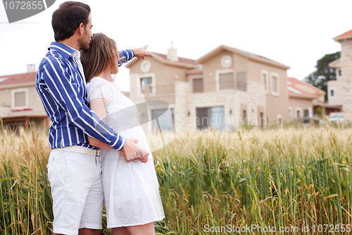 Image of Young romantic couple standing together