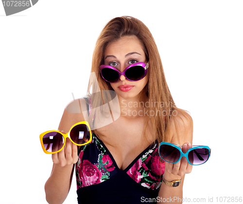 Image of Young woman holding different colors of sunglasses