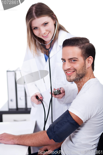 Image of Female doctor checking blood pressure