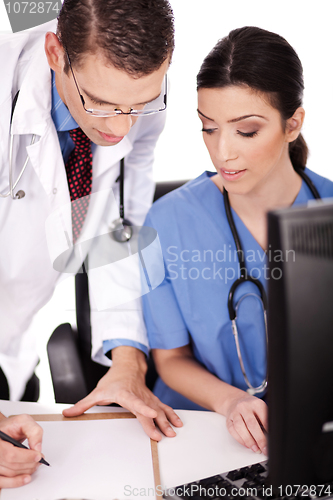 Image of Young doctors discussing and making notes