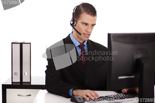 Image of profesional verfying data on his computer
