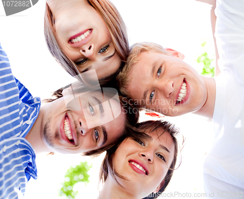 Image of Smiling young couples with clear sky in the background