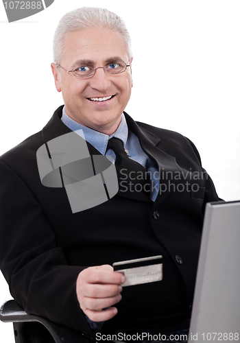 Image of Senior business man making online purchase with his credit card
