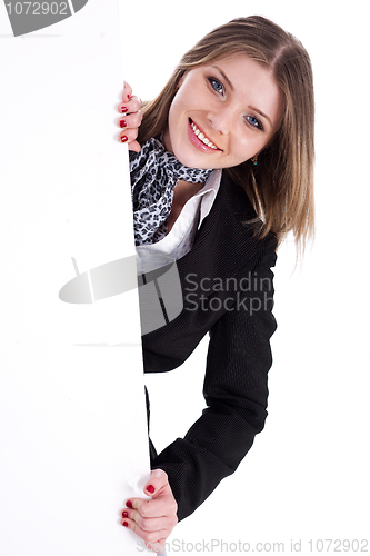 Image of Happy young women peeking through a blank board