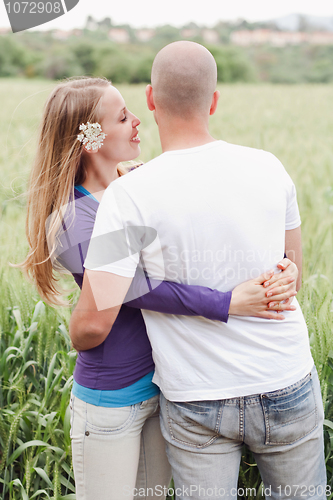Image of Young romantic couple standing together