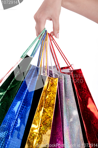 Image of Colorful shopping bags holding by human hand