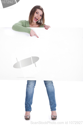 Image of Happy beautiful woman pointing out the blank white board