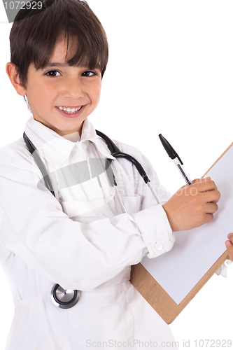 Image of Little boy doctor writes on his clipboard for diagnosis