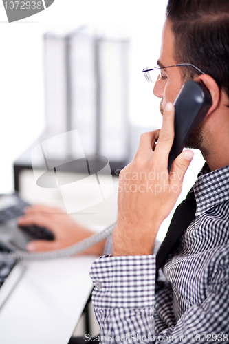 Image of business man busy with his telephone