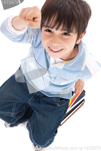 Image of Top view of cute kid with fingers up sitting on books