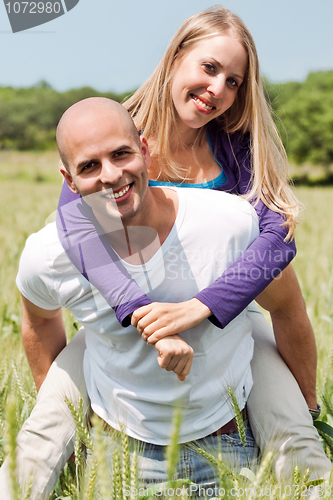Image of Two young lovers holding each other piggyback