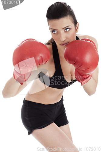Image of Sporty girl in boxing gloves punching