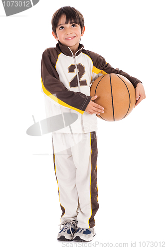 Image of Adorable young kid in his sports dress with basketball
