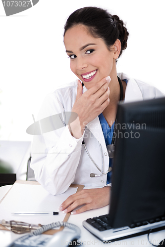 Image of Female doctor portrait smiling and looking computer
