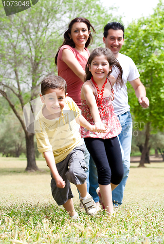 Image of Happy family having fun in the park