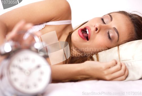 Image of Pretty girl on the bed in white bikini and yarning