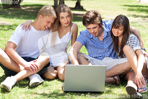 Image of Young boys and girl students using laptop