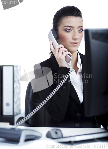 Image of Young business woman making a phone call at office