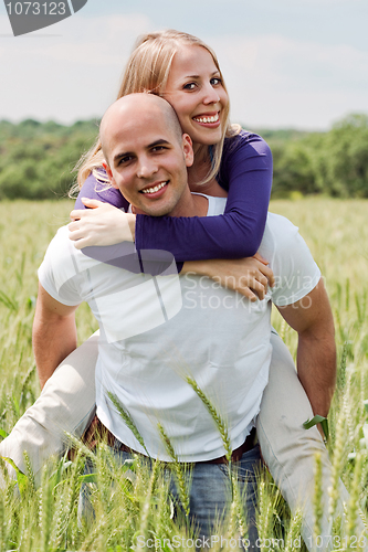 Image of Man piggybacking her girlfriend