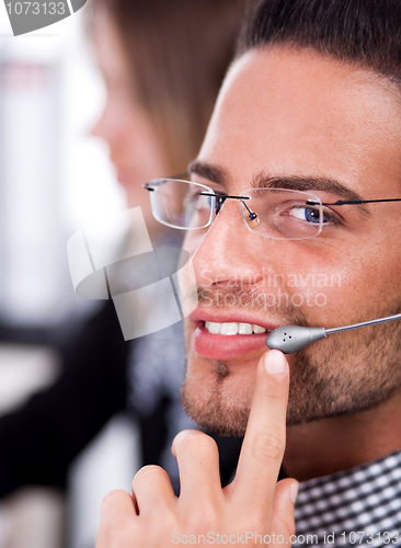 Image of business man speaking through head phone