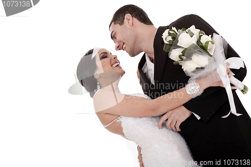 Image of Bride and groom just married posing happily