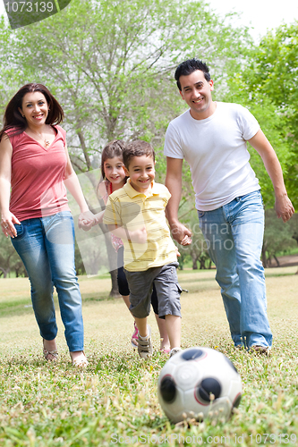 Image of Family  playing football and having fun
