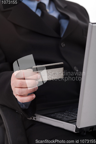 Image of Business man with credit card focus on card