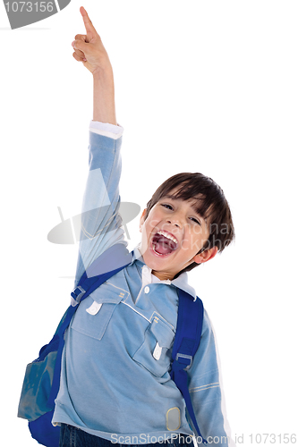 Image of Young school boy excitingly shouts and raise his hand up