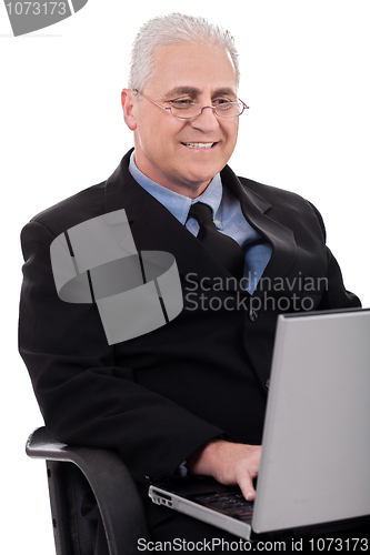 Image of Mature business man in working with laptop