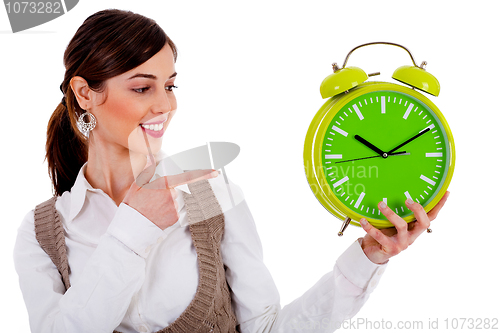 Image of lady pointing at alarm clock