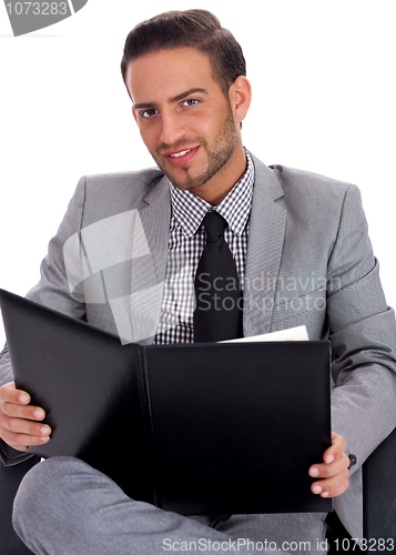 Image of Young business man holding a clip board