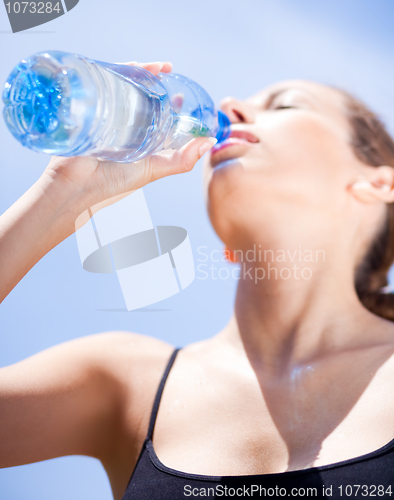 Image of Fitness woman drinking water