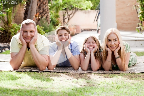 Image of Lovely family on there backyard and looking at you