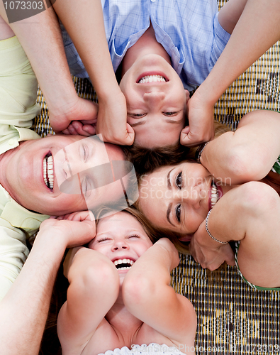 Image of Happy family lying in a circle