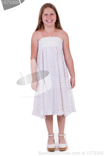 Image of Full length of smiling young girl standing and looking at you